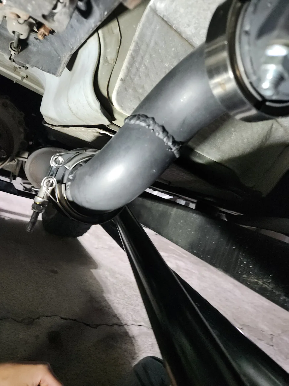Exhaust pipe with a welded bend and band clamp