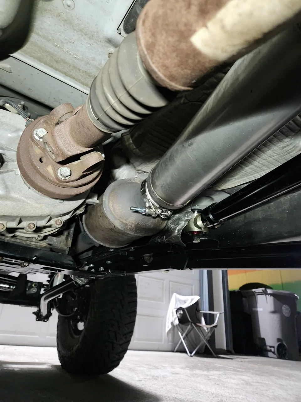 Front driveshaft and exhaust seen from under a 4x4
