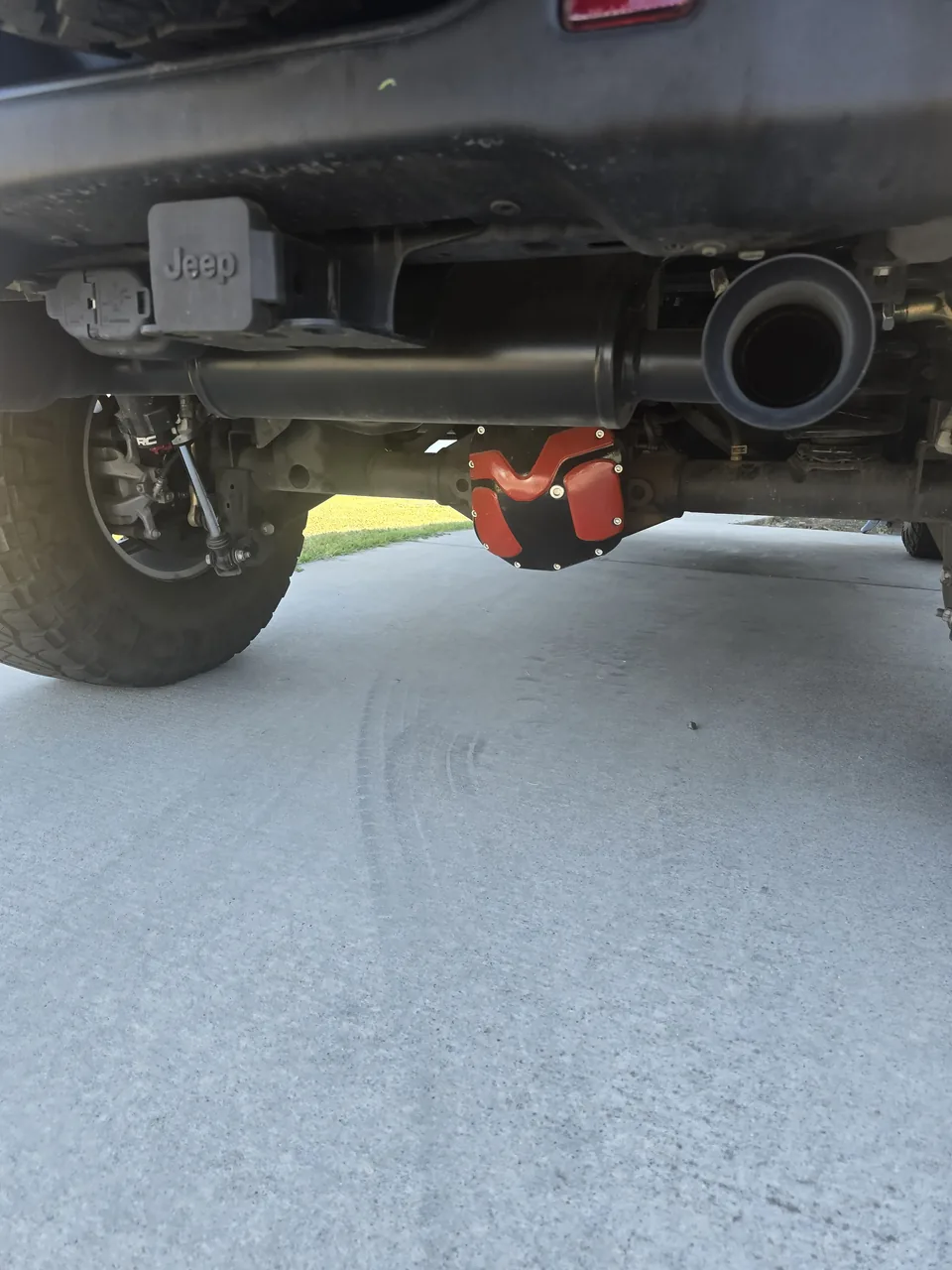Lifted Jeep rear axle with a new red differential cover