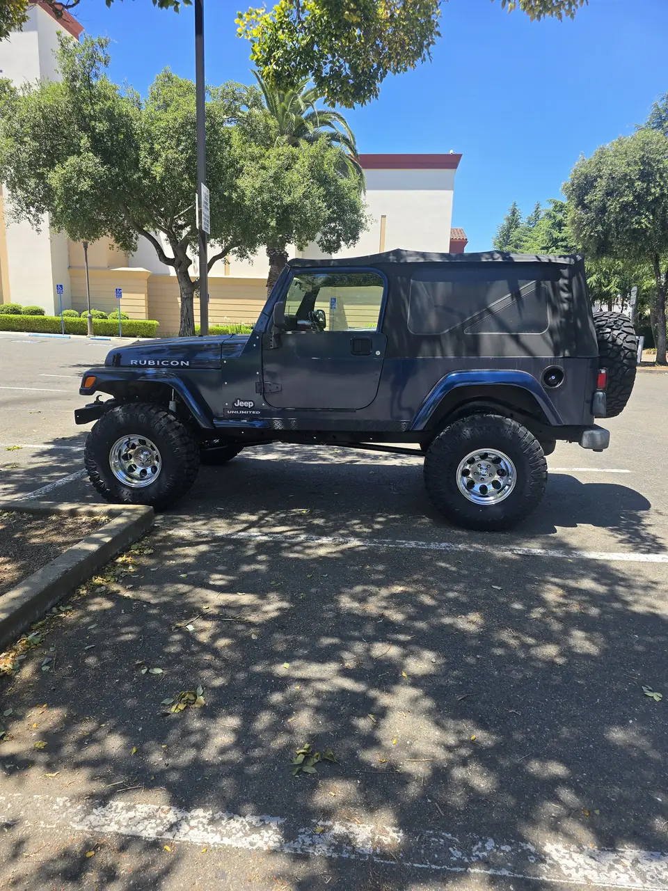 Lifted Jeep Wrangler on oversized tires, side profile