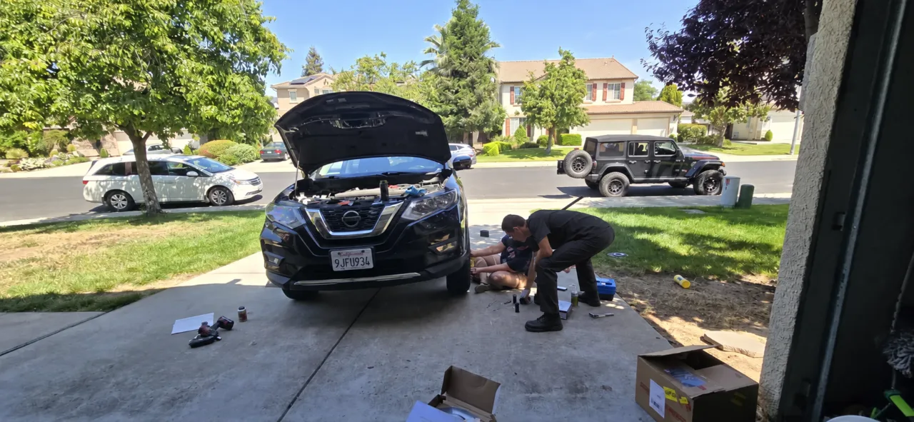 Mobile mechanic repairing a car in the customer's driveway in Sacramento