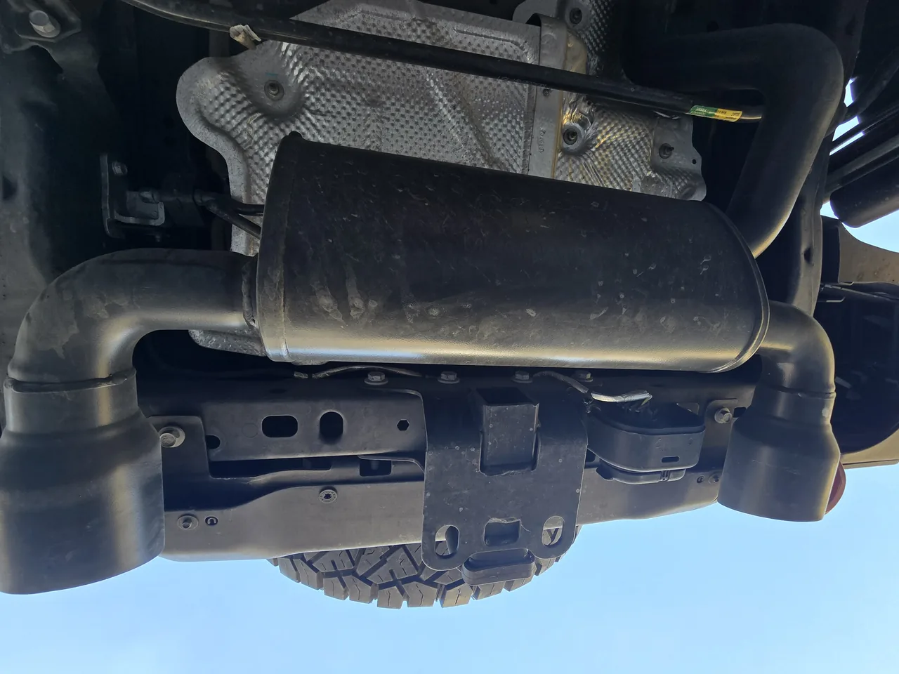 Muffler and exhaust under a lifted Jeep